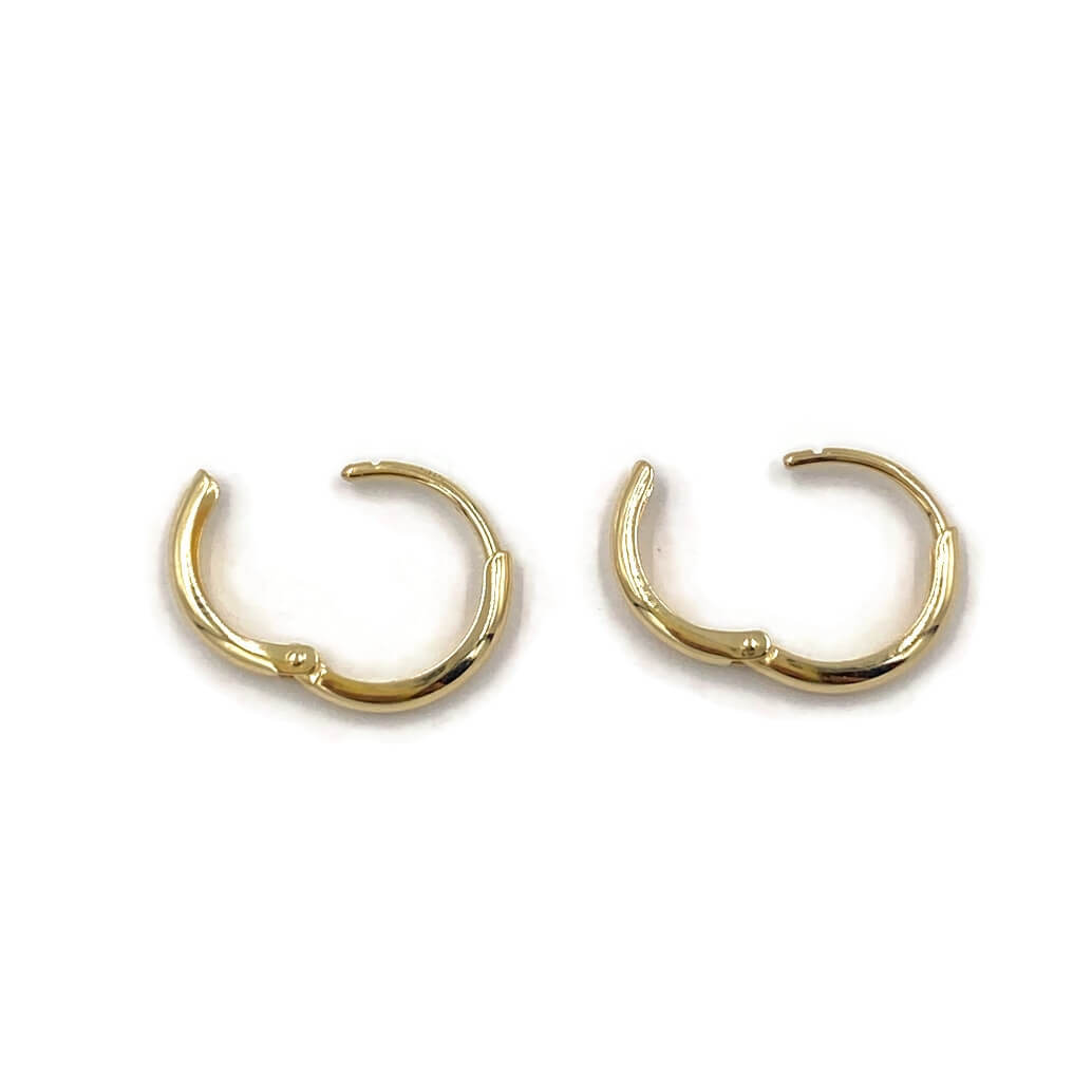 This is a pair of 14k solid gold huggie earrings that are open.