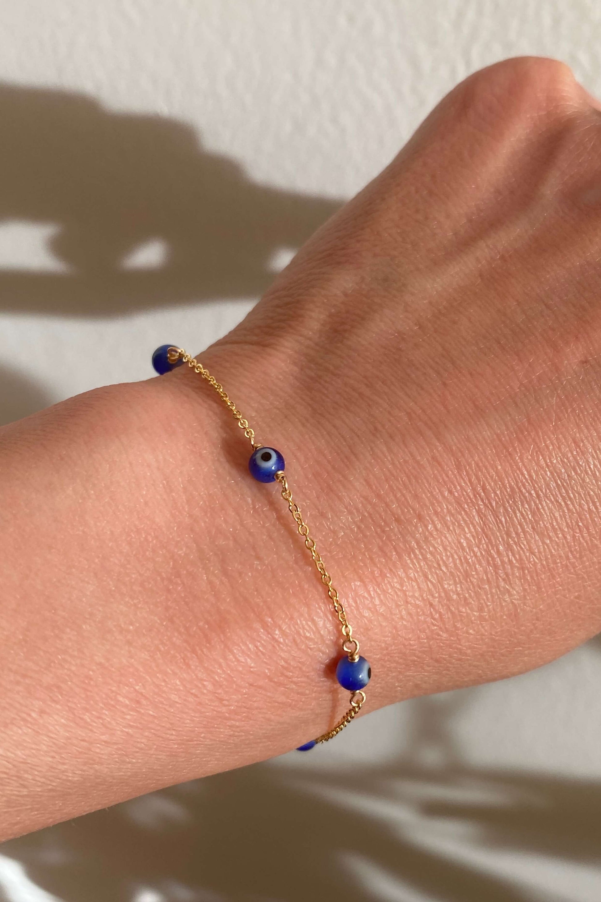 This is a blue evil eye bracelet that is made of real evil eye beads with dainty gold filled chain.