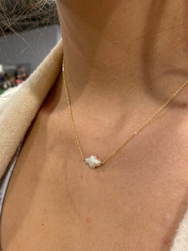 This a sideway cross pearl necklace that's 16" long and made of gold filled chain.