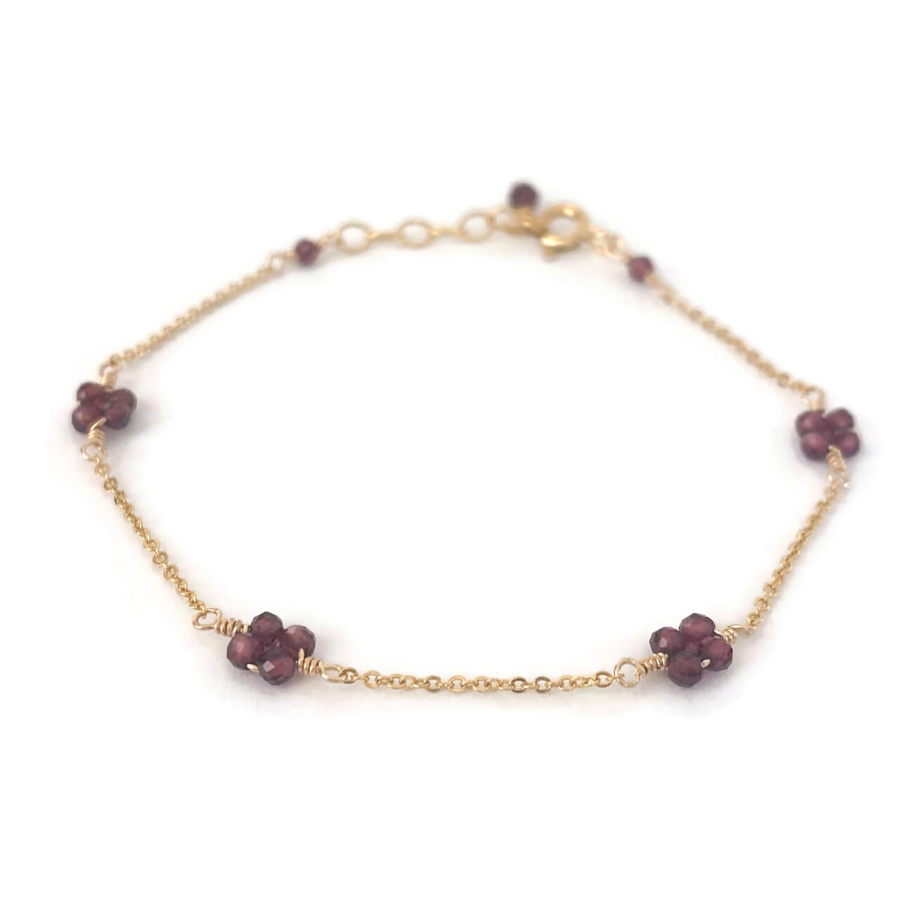 Garnet flower bead bracelet in station style made in gold chain.