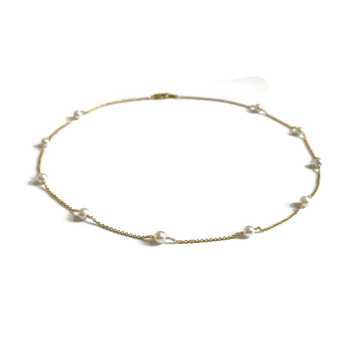 This is a dainty pearl station necklace that is made of gold filled chain and genuine 4mm fresh water pearls.