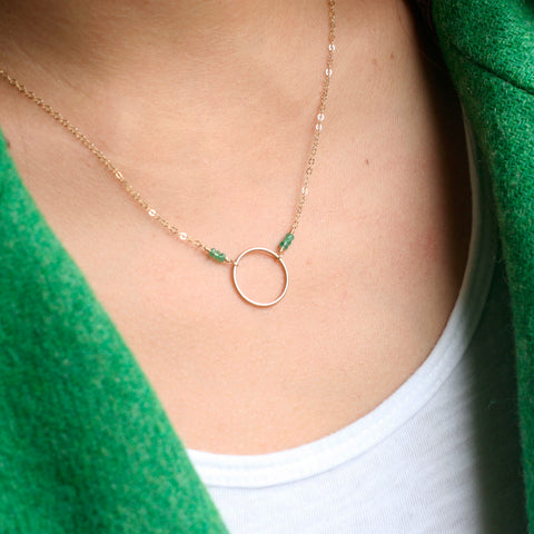 This is an emerald circle necklace. 