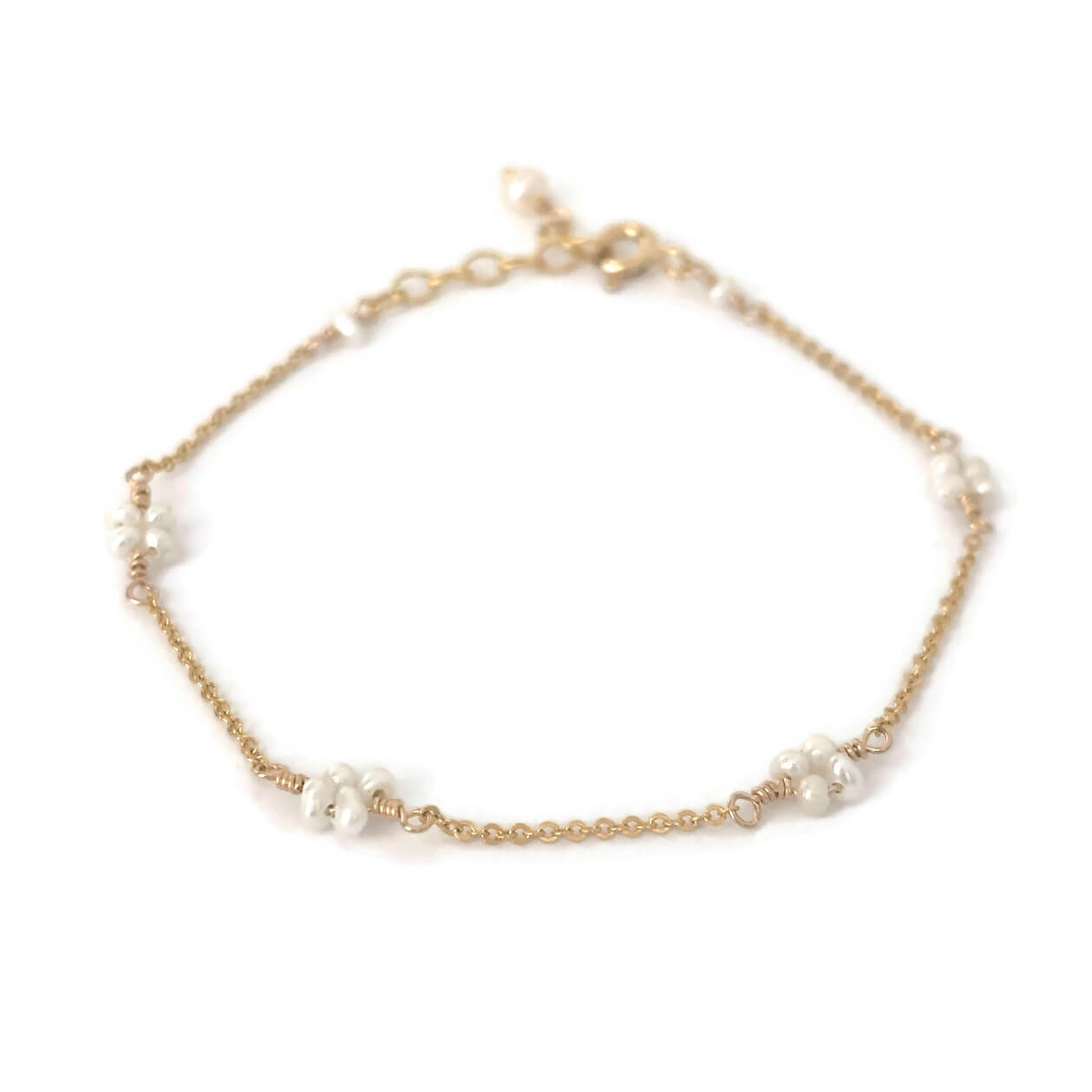 Dainty pearl bracelet in flower pattern made in gold filled chain.