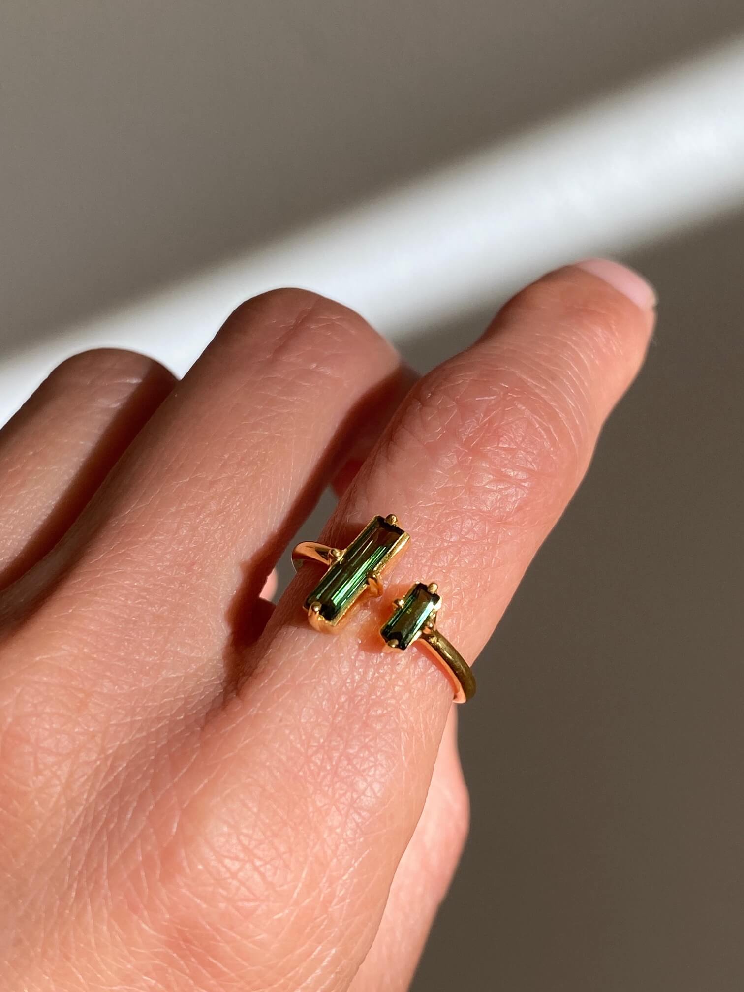 This is a green tourmaline cocktail ring that is adjustable.