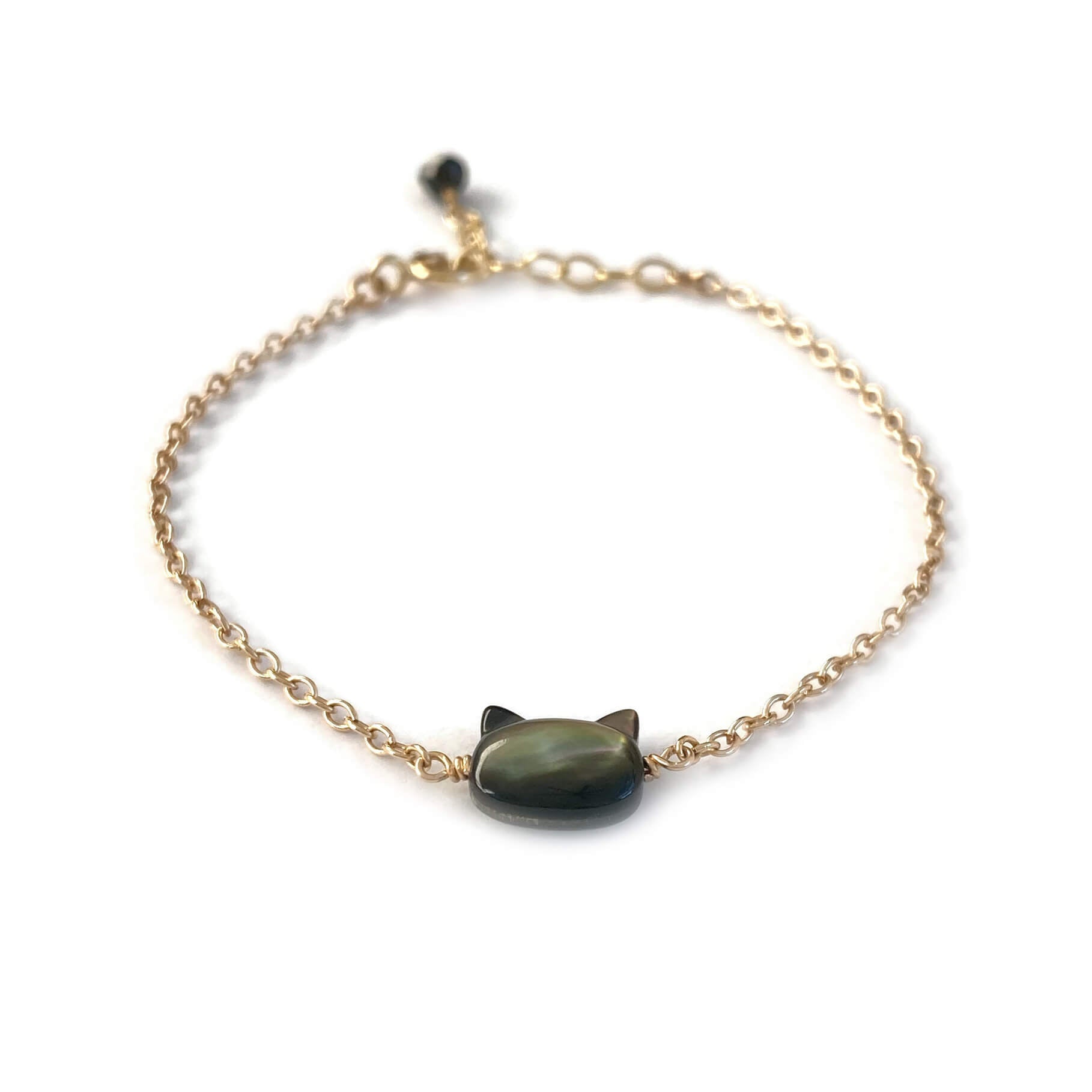 This is a black cat bracelet that is made of genuine black mother of pearl from Tahiti and gold filled chain. It's adjustable 6" to 7" with a dangling Black Tourmaline.