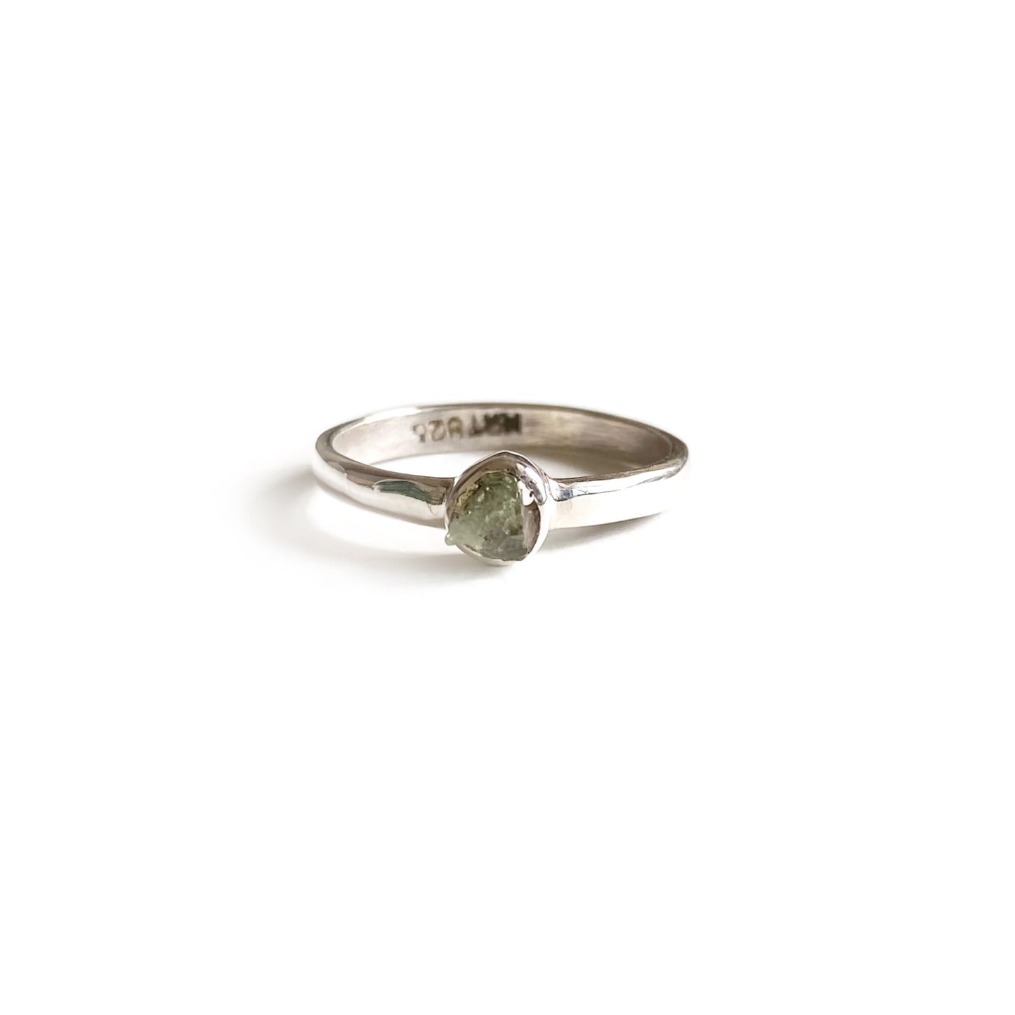 This is a moldavite ring that is made of rough uncut genuine Moldavite with sterling silver