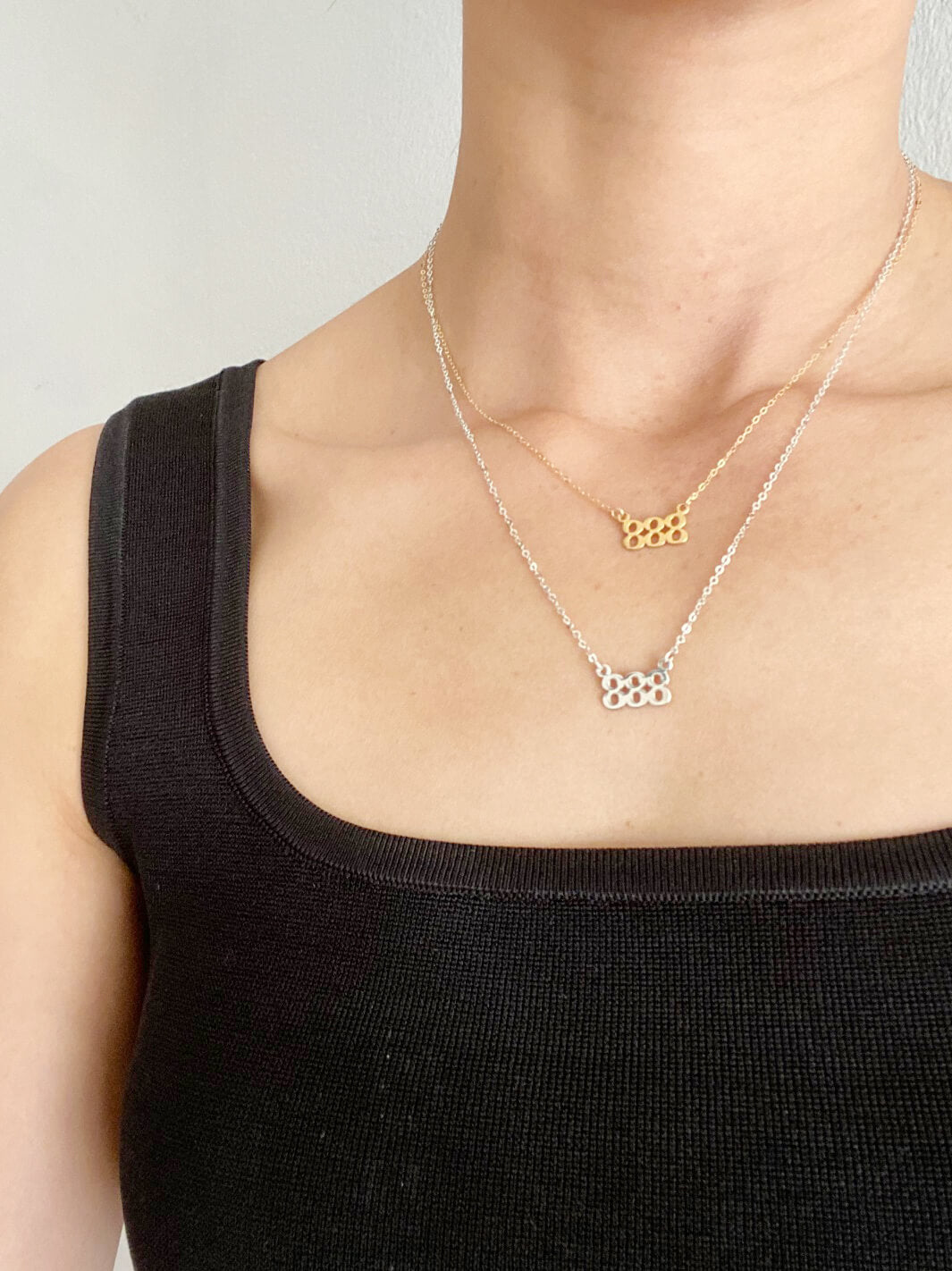 We layer 2 of the 888 necklaces to show you 16" and 18" necklaces. The top one is a gold 888 Angel number necklace and the bottom one is a silver 888 Angel number necklace.