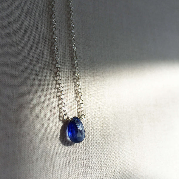 This blue sapphire necklace is translucent and non opaque.  It's made of a genuine single sapphire bead around 8mm by 5 mm with a sterling silver chain.  