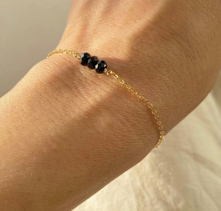This is a black tourmaline bracelet. It's made of high quality black tourmaline beads with gold filled chain. It's adjustable 6" to 7".