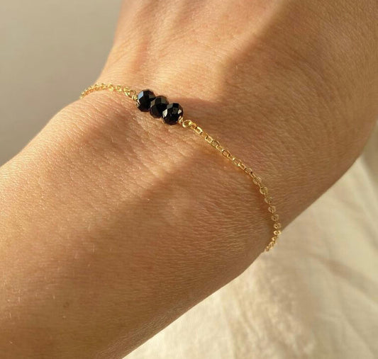 This is a black tourmaline bracelet. It's made of high quality black tourmaline beads with gold filled chain. It's adjustable 6" to 7".