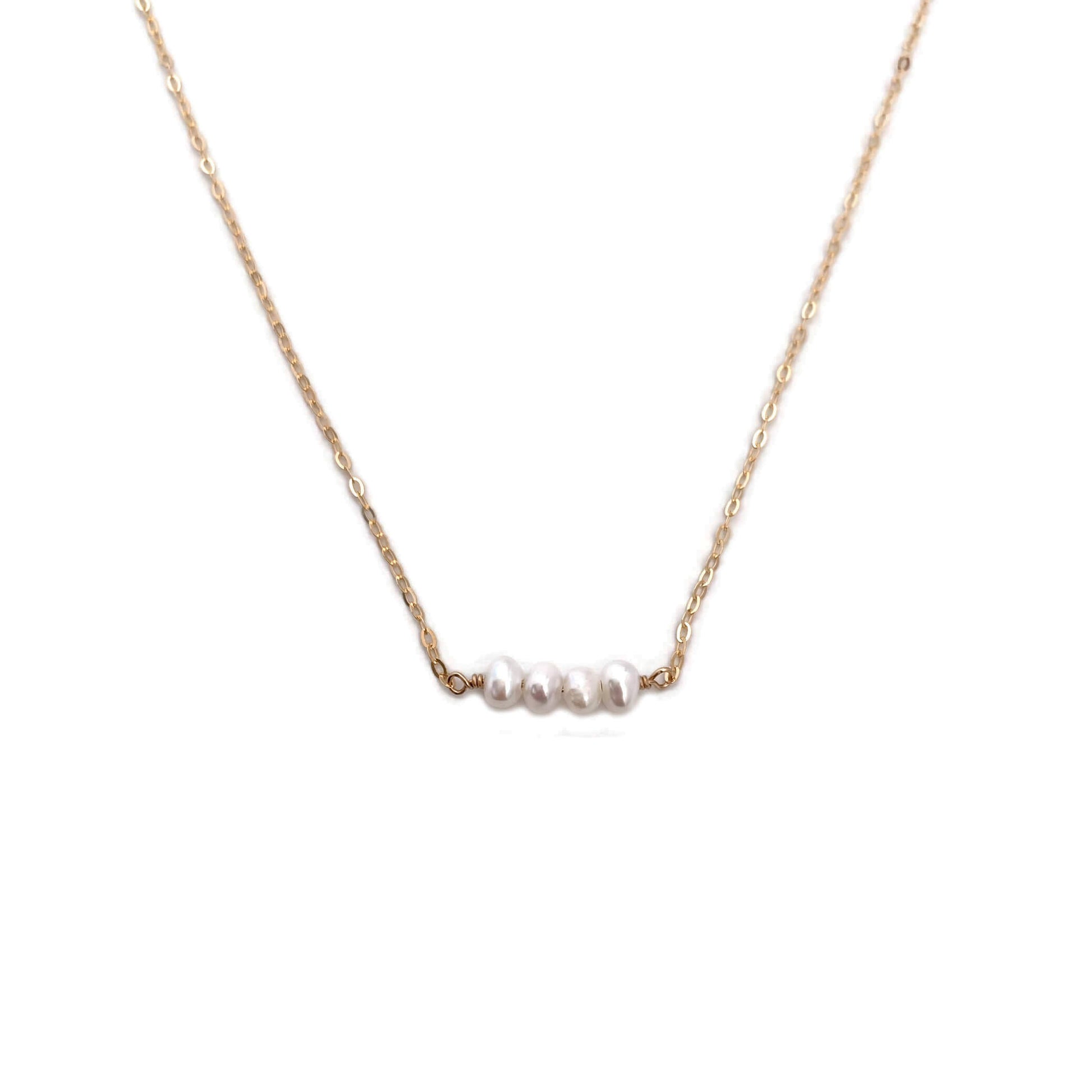 The dainty pearl bead necklace is simple and dainty.  It's made of 14k gold chain with four fresh water pearl beads.