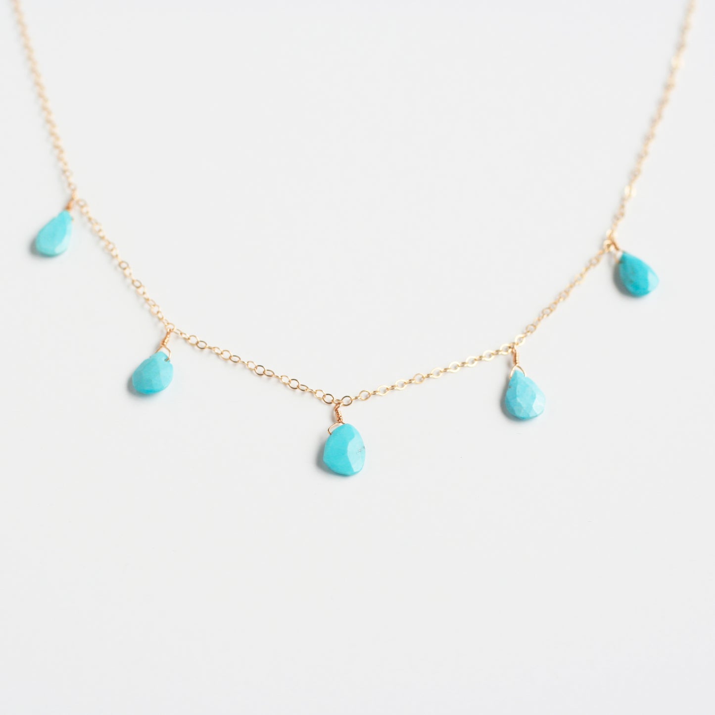 This dangling turquoise necklace is made of real turquoise beads and 14k gold chain.