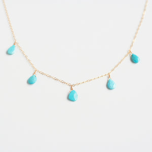 This dangling turquoise necklace is made of real turquoise beads and 14k gold chain.