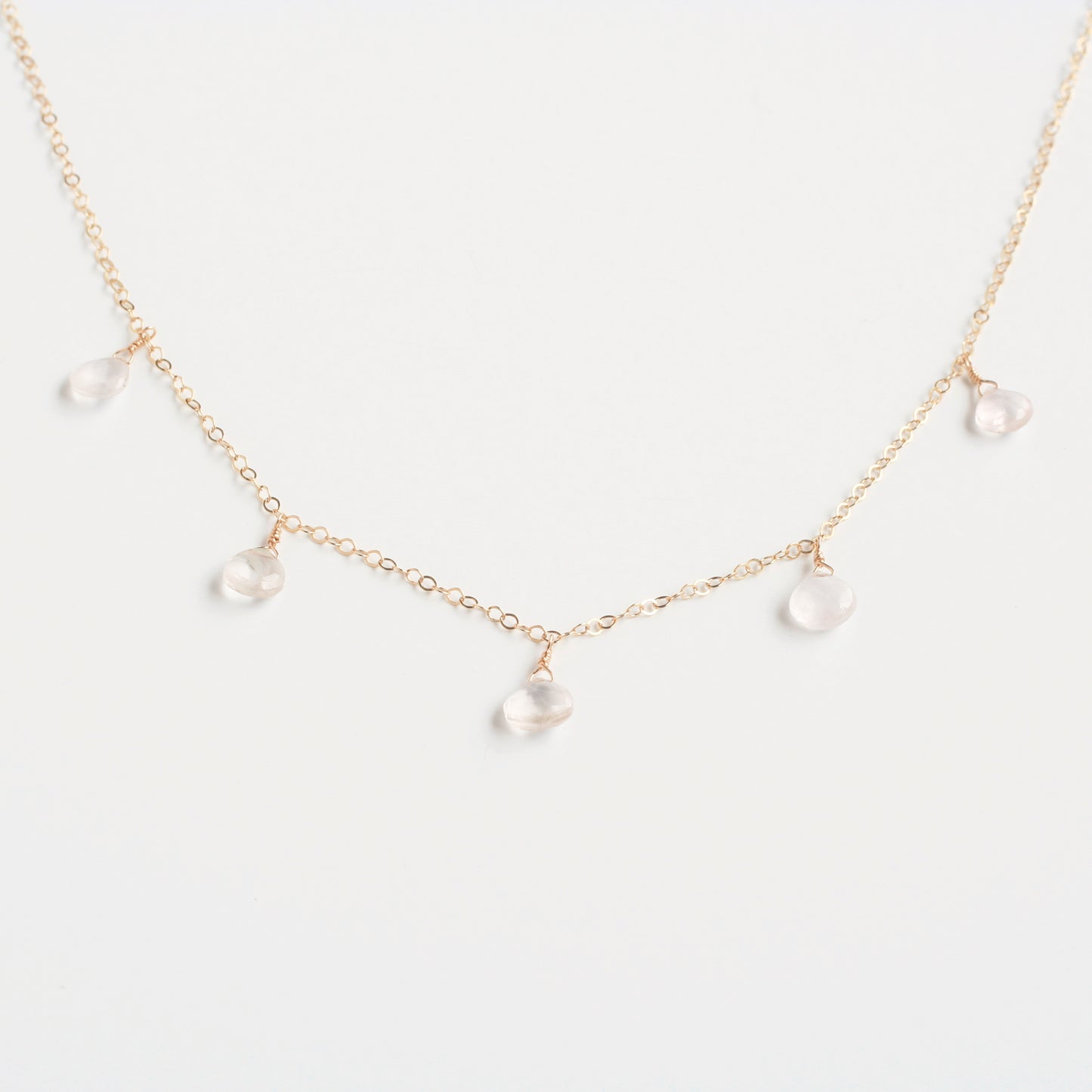 This rose quartz necklace is a dangling necklace. It's made of real rose quartz crystal with 14k gold chain.