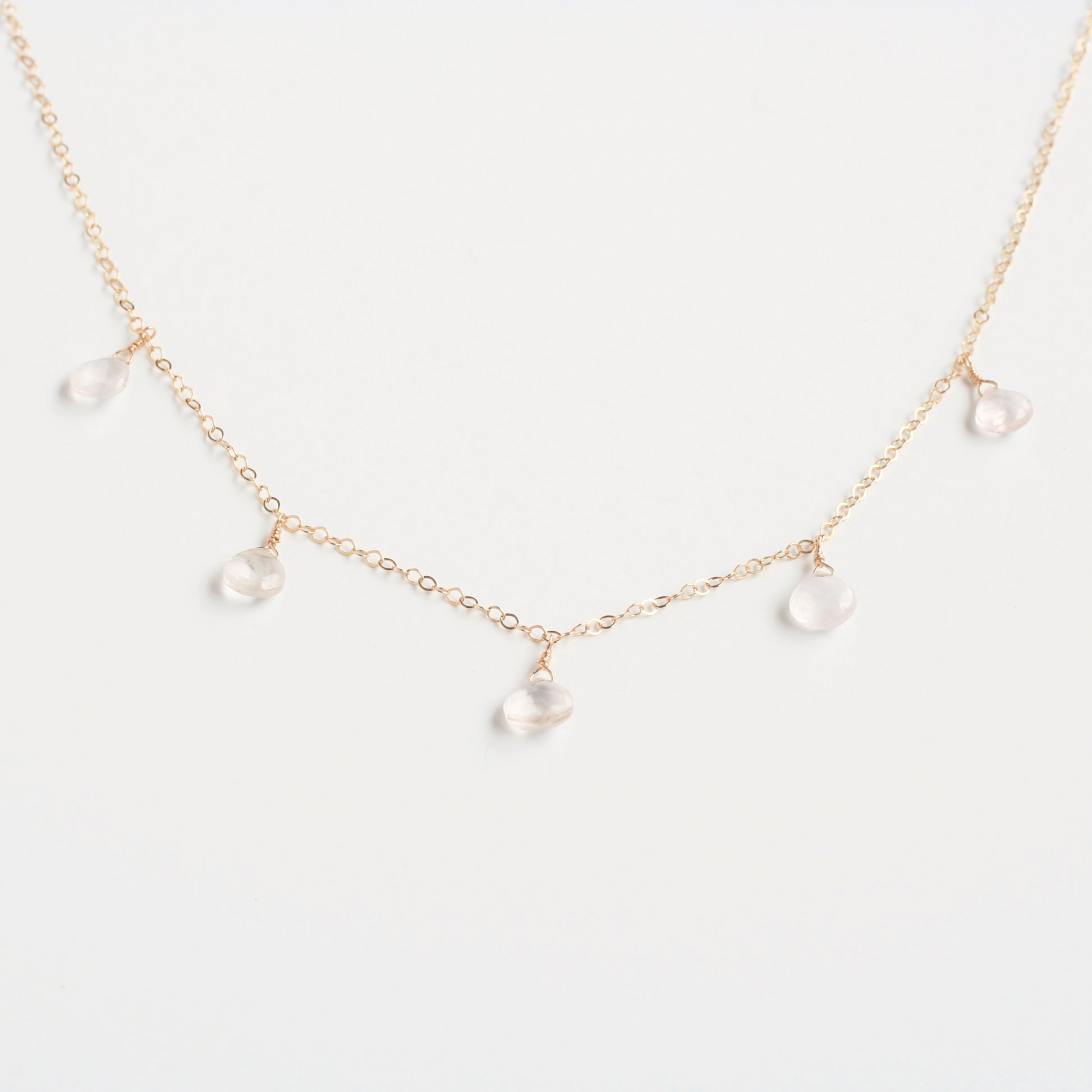 This rose quartz necklace is a dangling necklace. It's made of real rose quartz crystal with 14k gold chain.