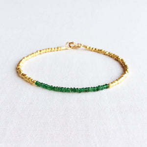 this beaded emerald bracelet exudes a timeless look that would be fit for a queen.  The dainty emerald bracelet is made of hand-selected green emeralds and 24k gold plated beads. 