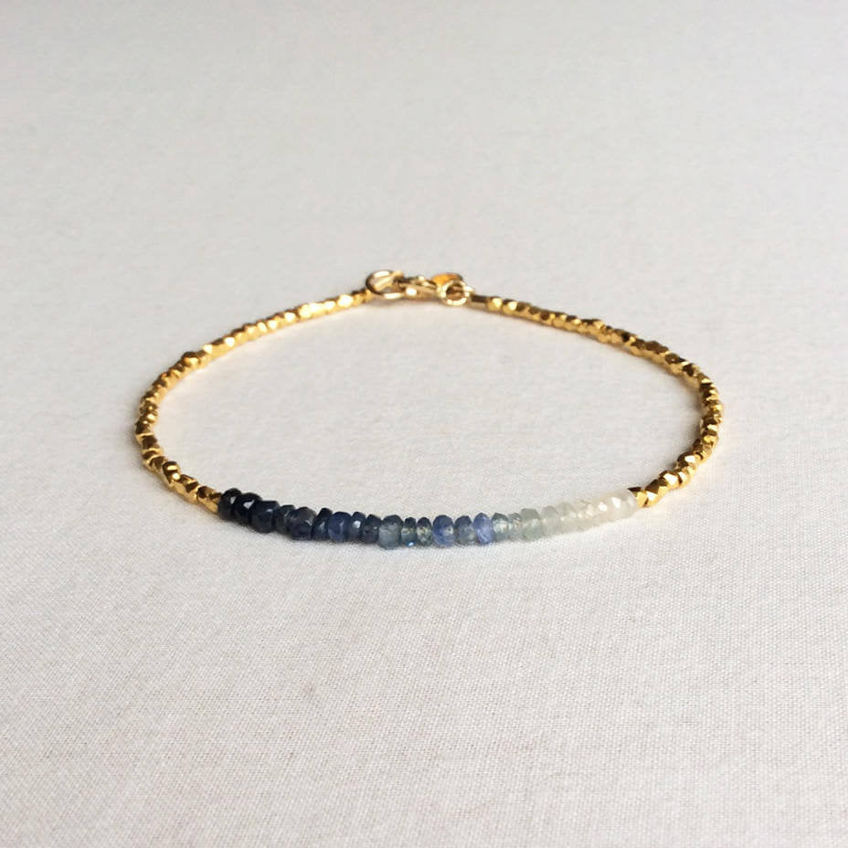 this ombre sapphire bracelet exudes a timeless look. The bracelet is made with hand-selected sapphires that have different shades of blue – from nearly white to deep navy blue.