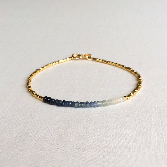this ombre sapphire bracelet exudes a timeless look.  The bracelet is made with hand-selected sapphires that have different shades of blue – from nearly white to deep navy blue.