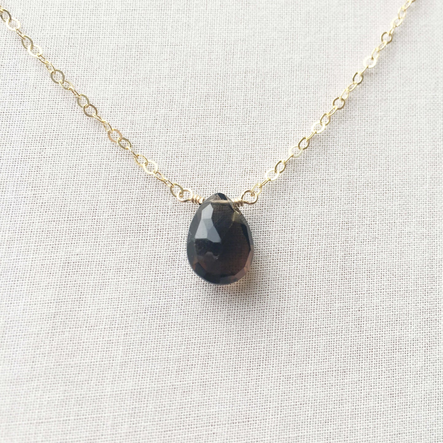 This smoky quartz gold necklace features a single grey gemstone attached to a 14k gold, gold fill or sterling silver chain.
