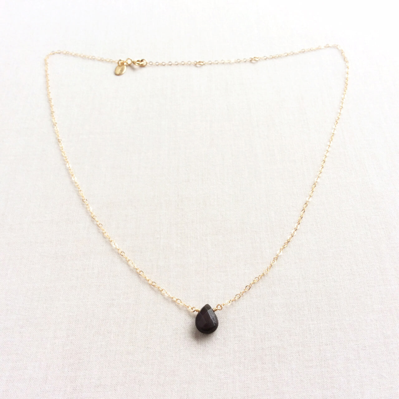 This simple but sophisticated dainty obsidian necklace is made with a single black obsidian gemstone.