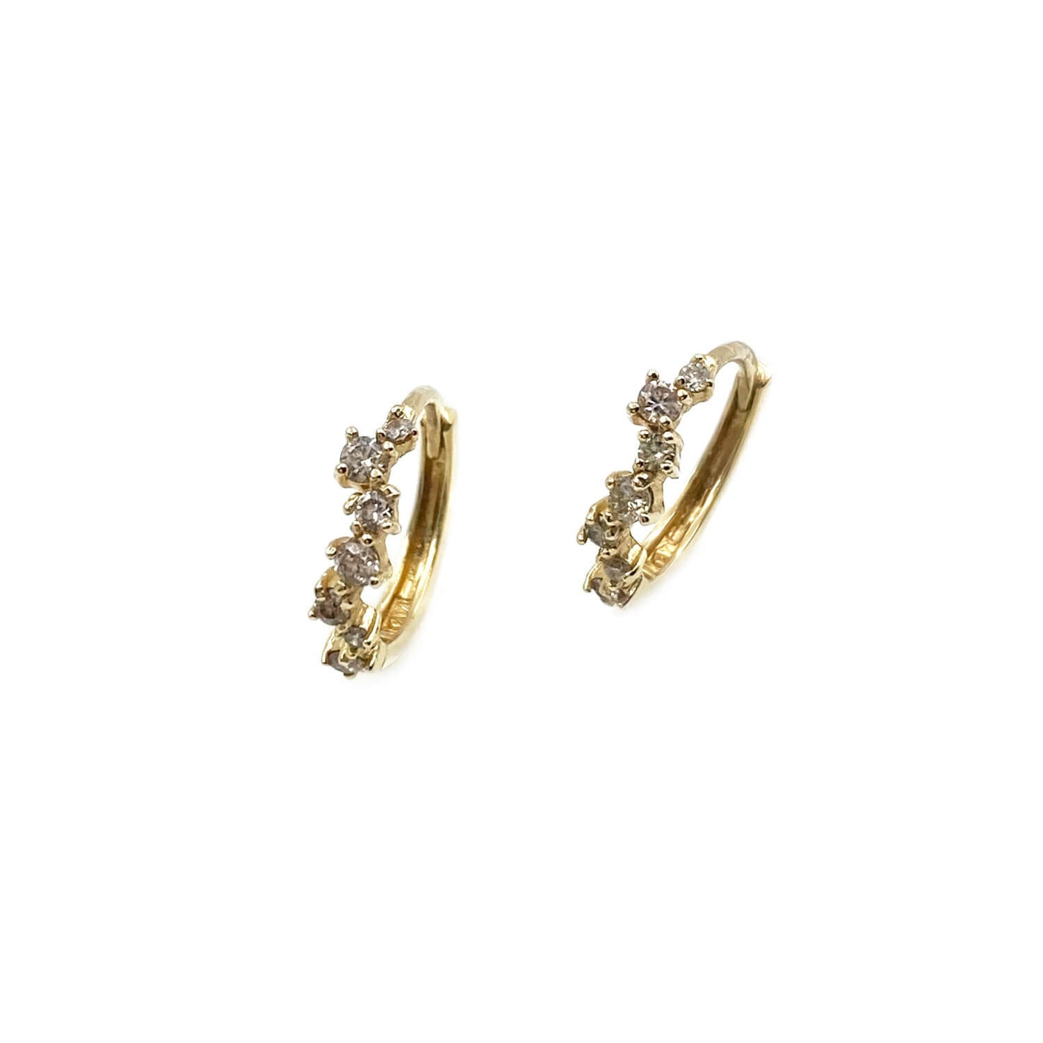 There are 14k diamond huggie hoop earrings that are made of natural diamonds with 14k gold.