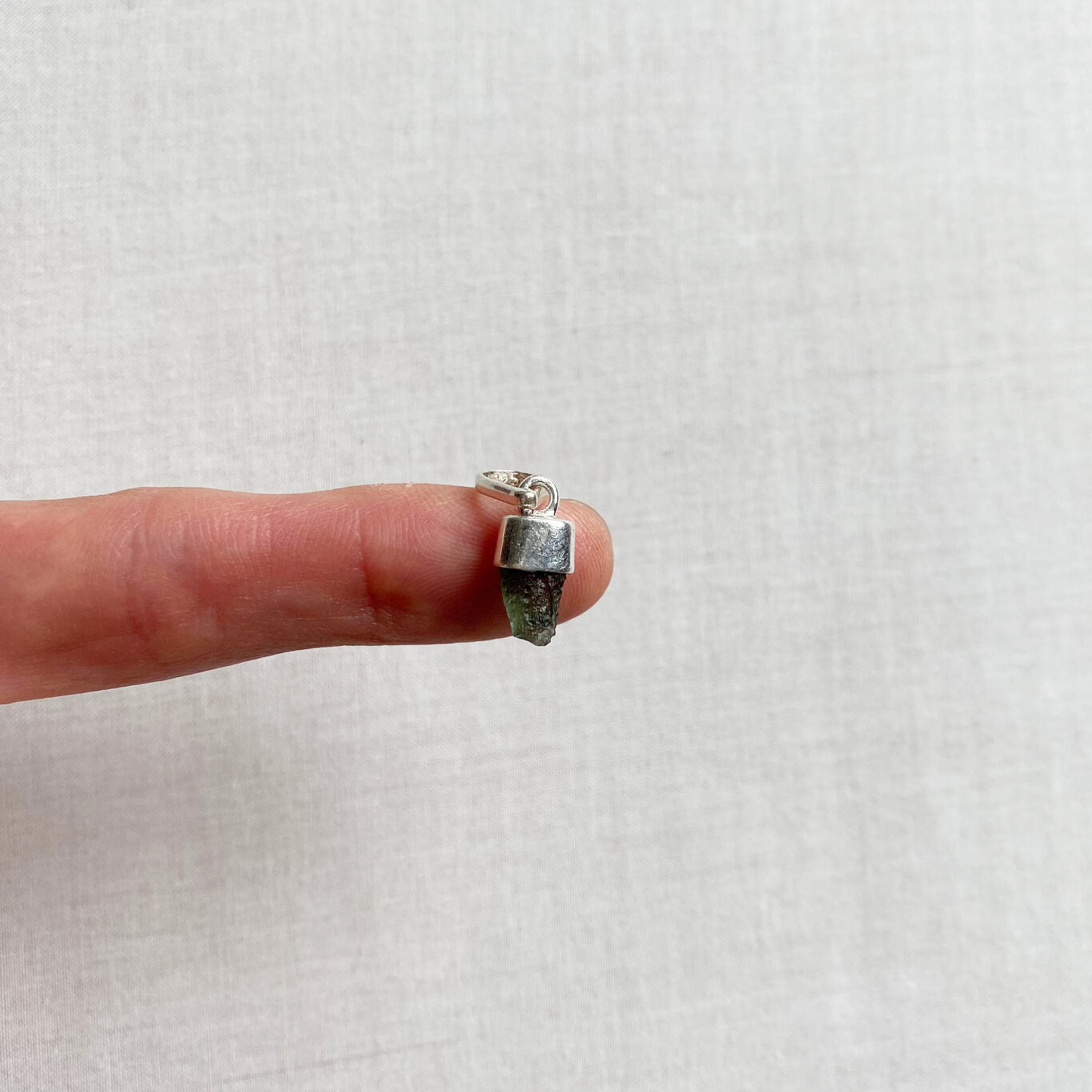 This moldavite pendant size is tiny. It's small but powerful.