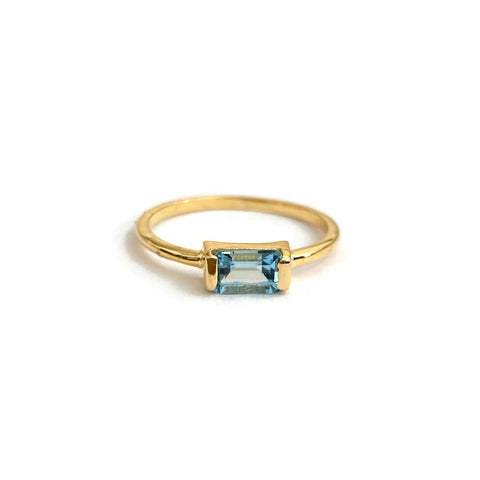 This is a Baguette Blue Topaz Ring that's made of genuine Blue Topaz with sterling silver plated with thick 18k gold. 