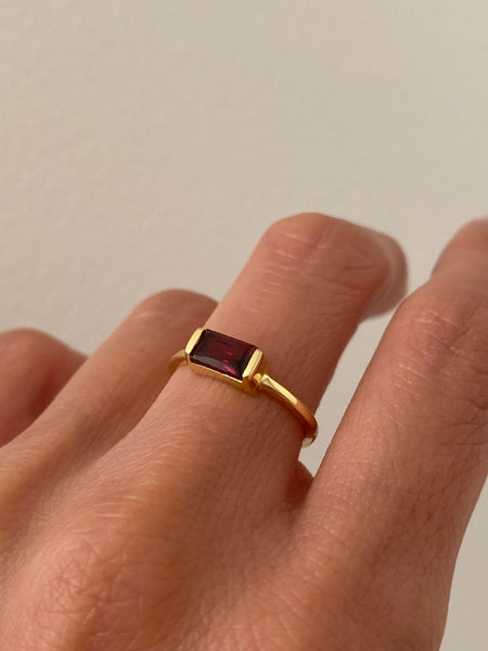 This is a dainty baguette Garnet ring.