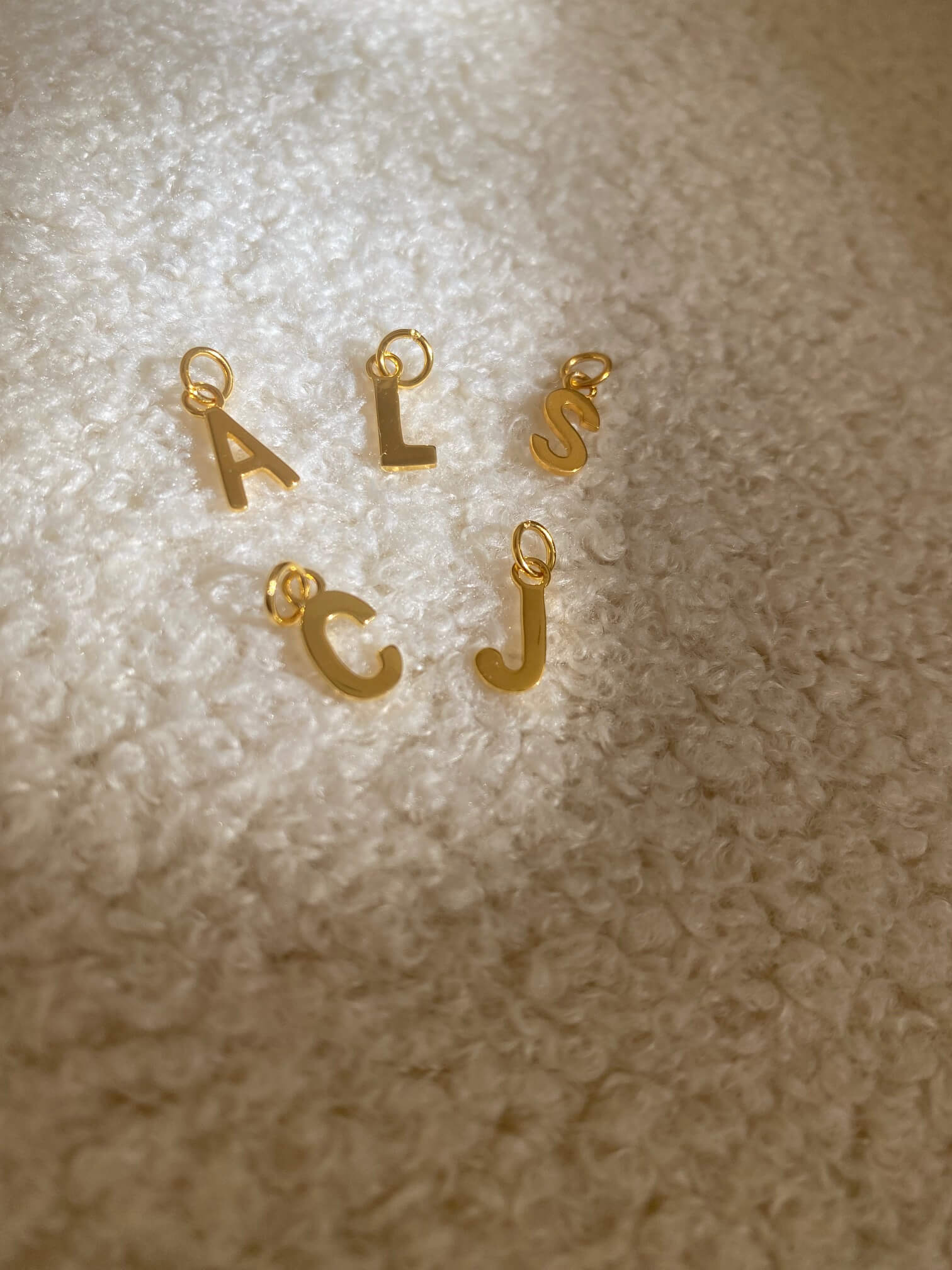 This is the initial letter charm set. They are made of sterling silver plated over gold.