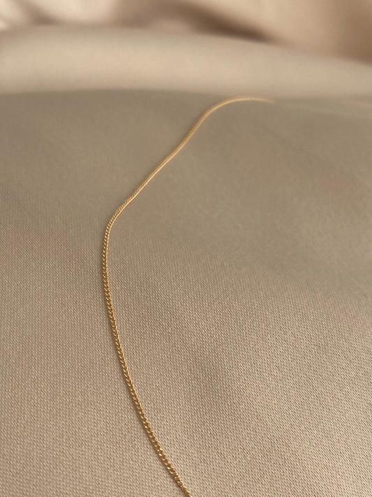 This is a 14k dainty curb chain that is made of 14k solid gold. It's made in Italy by a third generation gold chain family business.  