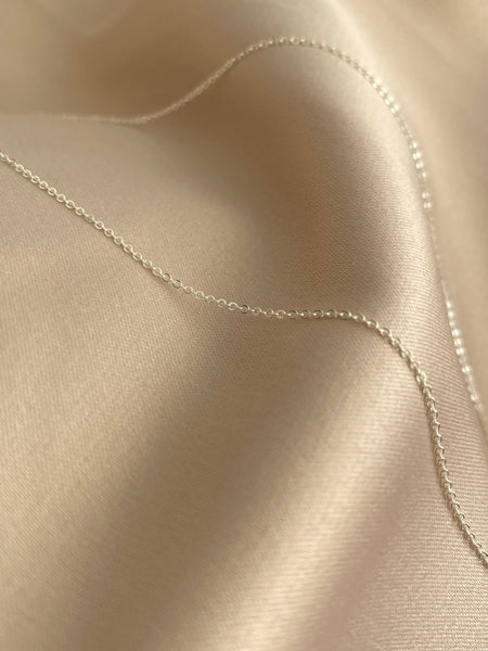 This is a dainty sterling silver chain that can be 16" or 18". 