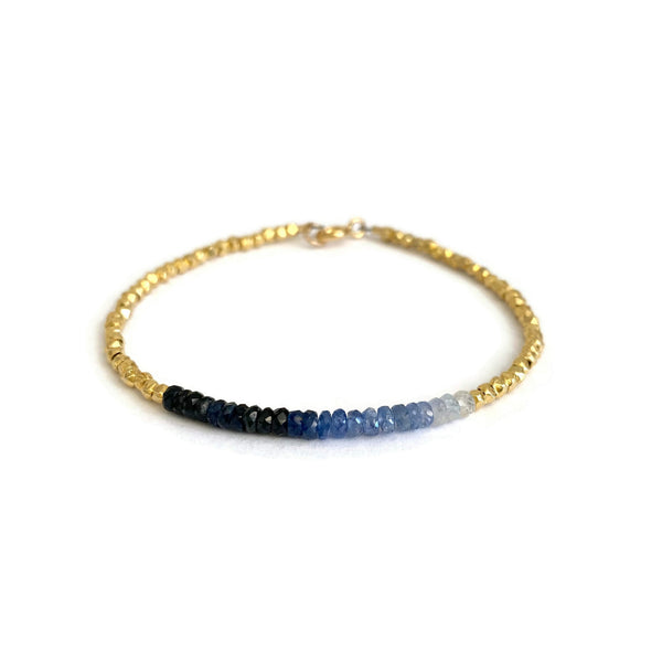 This Sapphire bracelet is made of 14k solid gold beads with genuine Sapphire with gradient blue color from dark to light blue.