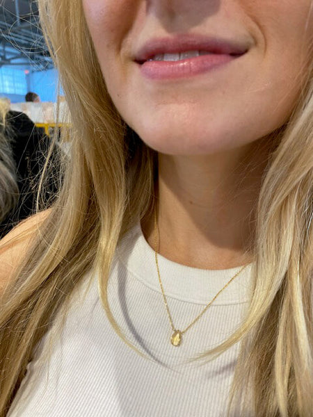 This natural citrine necklace is made of dainty 14k gold chain and one single real citrine gemstone. The model is wearing it at 18 inches long.
