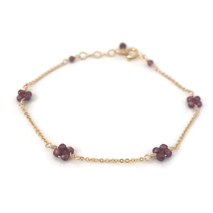 Garnet flower bead bracelet in station style made in gold chain. 