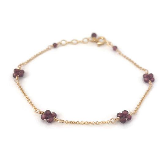 Garnet flower bead bracelet in station style made in gold chain. 