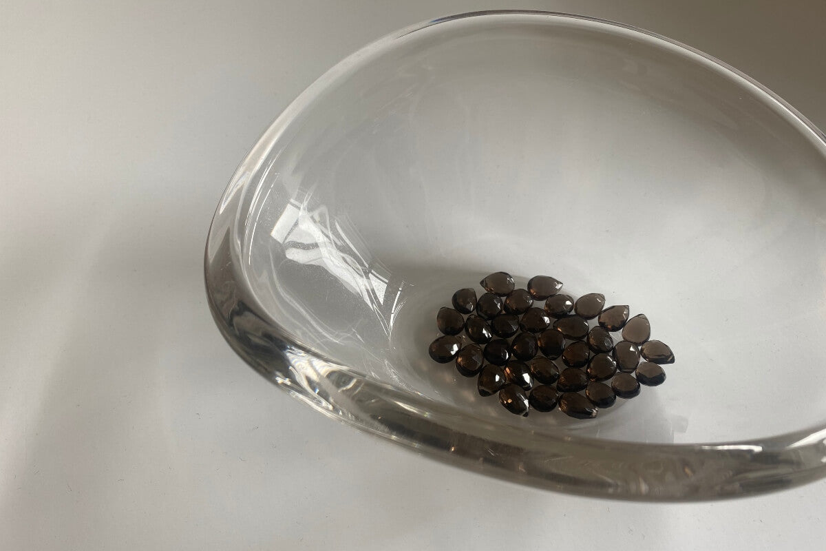 High quality smoky quartz gemstones inside a beautiful glass bowl 