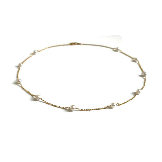 This is a dainty pearl station necklace that is made of gold filled chain and genuine 4mm fresh water pearls. 