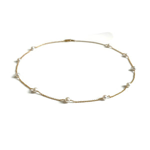 This is a dainty pearl station necklace that is made of gold filled chain and genuine 4mm fresh water pearls. 