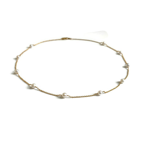 This is a dainty pearl station necklace that is made of gold filled chain and genuine 4mm fresh water pearls. 