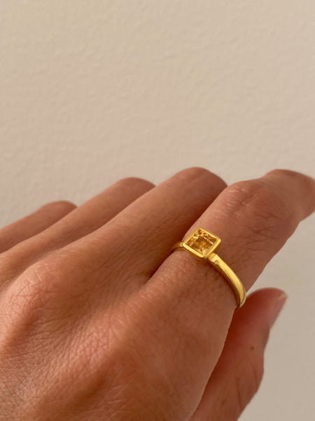 This is a square citrine ring that is made of citrine and sterling silver plated over 18k gold. 
