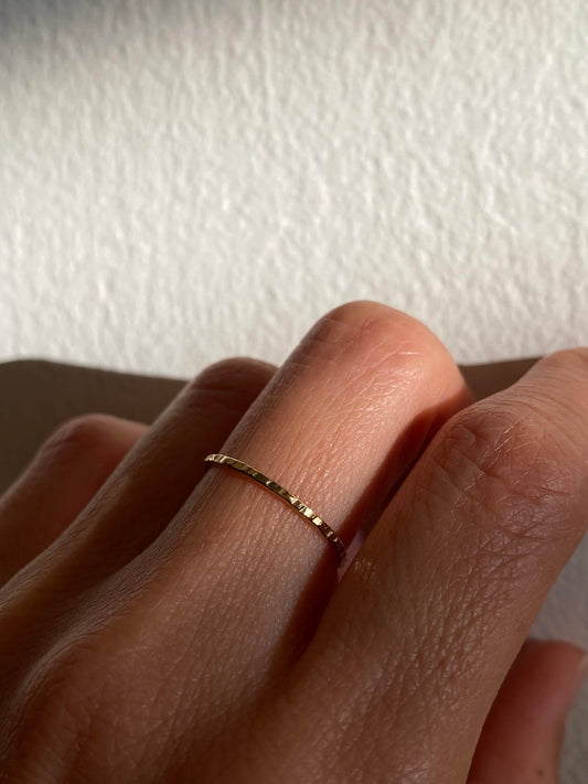 This is a dainty hammered texture gold filled ring that is made of 14k gold filled wire.