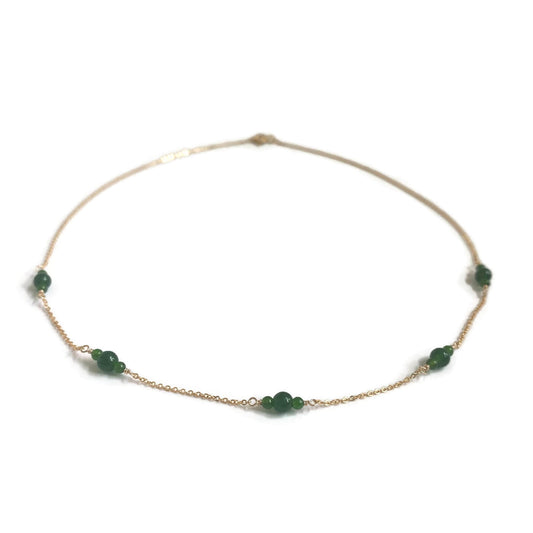 Gold necklace with genuine jade beads on a delicate 14k gold chain.