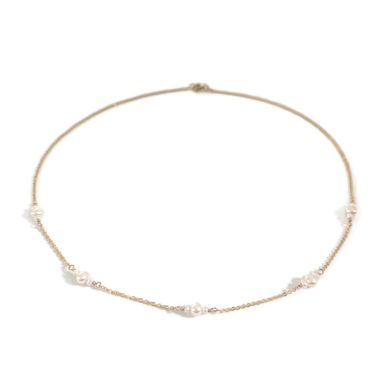 Dainty gold necklace with genuine fresh water pearls in station style.