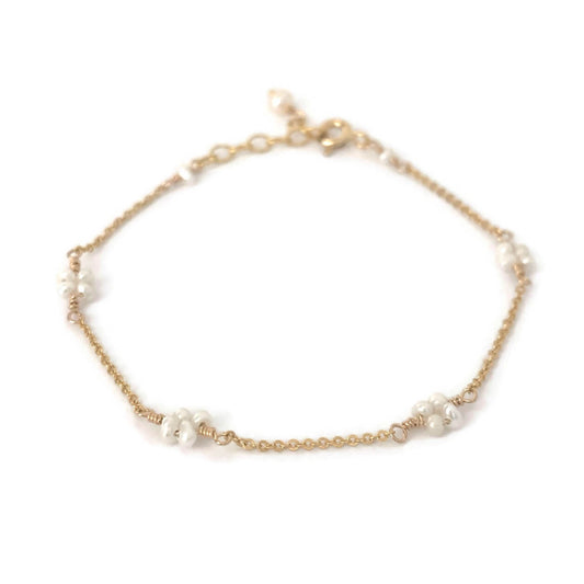 Dainty pearl bracelet in flower pattern made in gold filled chain.