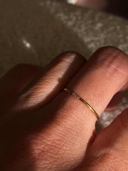 This is a tiny sparkle ring that is made of 3 tiny cubic zirconia and gold filled wire