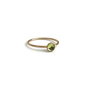 This is a dainty peridot ring that's made of 4mm peridot with gold filled wire.