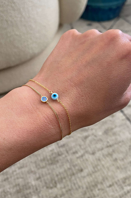 There 2 gold evil eye bracelet that is made of 14k solid gold and gold filled material. They are both dainty and can wear to shower. 