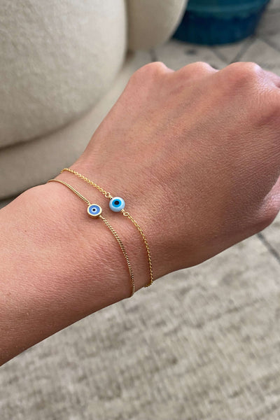 There 2 gold evil eye bracelet that is made of 14k solid gold and gold filled material. They are both dainty and can wear to shower. 