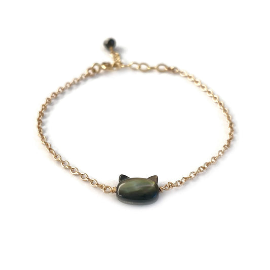 This is a black cat bracelet that is made of genuine black mother of pearl from Tahiti and gold filled chain. It's adjustable 6" to 7" with a dangling Black Tourmaline. 