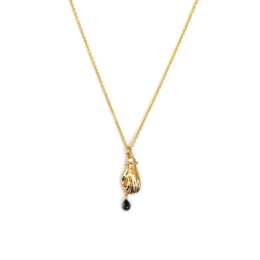 This is a receiving hand holding a dangling black diamond necklace. Made in gold filled chain. 